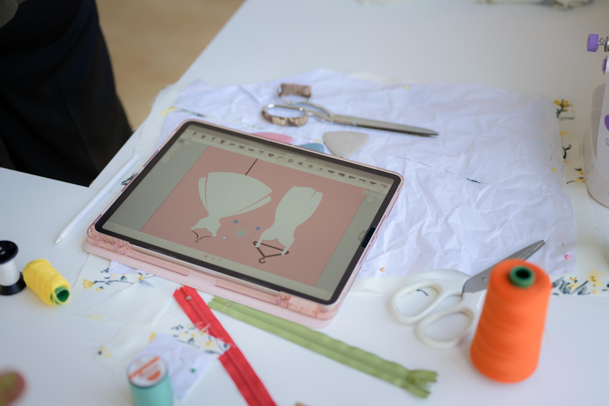 Workspace with hoop, threads and digital tablet